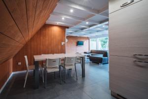a dining room with a table and chairs and a couch at Terrasses de Malmedy Chalet 113 in Malmedy