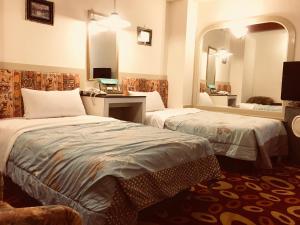 Ein Bett oder Betten in einem Zimmer der Unterkunft 真正好旅店 Good Hotel