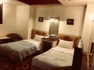Ein Bett oder Betten in einem Zimmer der Unterkunft 真正好旅店 Good Hotel