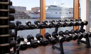 a rack of dumbbells in front of a window at Hotel Jakarta Amsterdam in Amsterdam