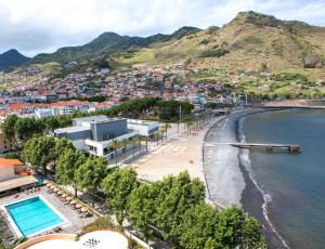 a view of a beach with a city and the ocean at Dom Pedro Madeira in Machico