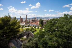 a view of a city with a factory in the background at TONI'S Charming Apartment 2BD, close Thisseo Metro in Athens