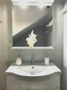 y baño con lavabo y espejo. en Sea-view maisonette at Sounio, en Sounio
