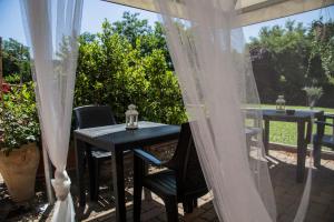 a table and chairs on a patio with curtains at Luxardotel in Rome