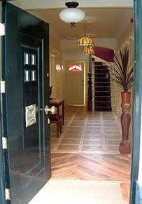 a hallway of a home with a door and a staircase at Ardwyn House in Llanwrtyd Wells