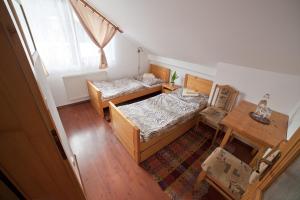 1 dormitorio con 2 camas, mesa y ventana en Hostinec u Hromadov - ubytovanie v súkromí, en Rajecká Lesná