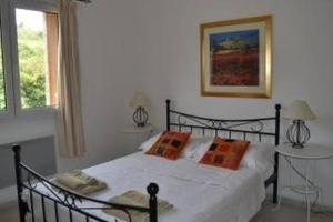 a bedroom with a bed and a table and a window at Maison de la Fontaine in Embres-et-Castelmaure