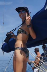 a woman in a bikini standing on a boat at Play to Live San Blas in El Porvenir