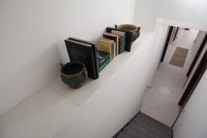 une étagère avec des livres dans un couloir dans l'établissement Casa Benzo, à Palerme