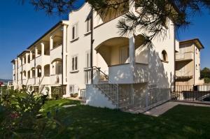 a large white building with stairs in front of it at Villetta Tina in Vada