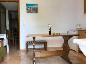 a kitchen with a wooden table in a room at Santa Catalina in Kalivia Poligirou