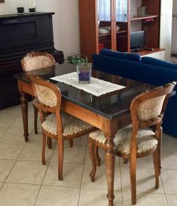 a dining room table with two chairs and a couch at My House for Florence, Airconditioned - Easy Parking in Scandicci