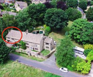 an aerial view of a large house with a red at Winwood Apartment in Holmfirth +2 photos