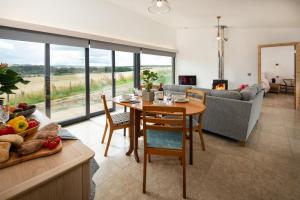 a kitchen and living room with a table and a couch at Orchard Hideaway in Kelso