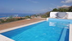 a swimming pool with a view of the ocean at Guest House Belvedere in Tropea