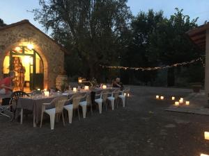 a group of tables and chairs with candles and lights at Agriturismo La Manonera in Montepulciano