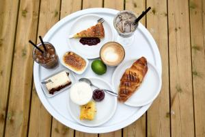 a white plate with different types of food on it at Sergel B&B Lindshammar in Lindshammar