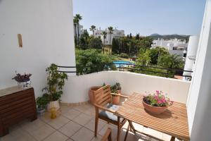 a balcony with a table and chairs on a balcony at Estepona Golf - Los Pintores in Estepona