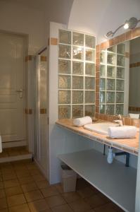 a bathroom with a sink and a shower at Hotel de la Plage in Le Lavandou