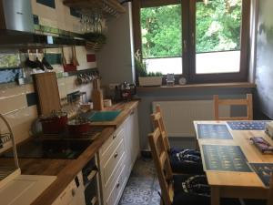 a kitchen with a counter and a table in it at Apartament LAZUR in Jastrzębia Góra