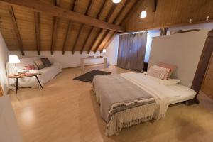 BnB Alpenblick في Lütisburg: غرفة نوم كبيرة مع سرير وأريكة