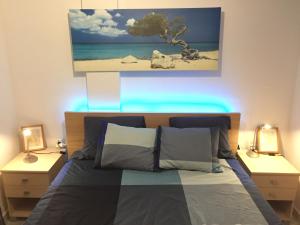 ein Schlafzimmer mit einem Bett und zwei Nachttischen mit Lichtern in der Unterkunft El Cortijuelo. Magnificent triplex terraced house with rooftop of 18m2, overlooking the sea. Parking in Torremolinos