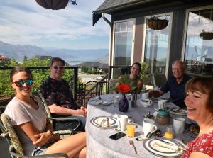 a group of people sitting around a table at Cheers B&B in West Kelowna