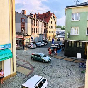 a city street with cars parked on the street at Ahoj Apartments in Ustka