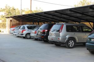 a row of cars parked in a parking lot at Tsokas Hotel in Finikounta
