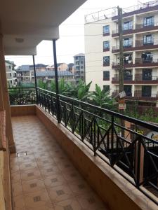 a balcony with a view of a building at A Home away from home in Ruaka