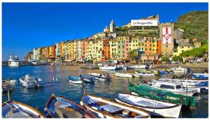 a group of boats docked in a harbor with buildings at La BouganVilla in Portovenere