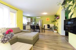 a living room with a couch and a kitchen at Apartment Mar in Kostrena