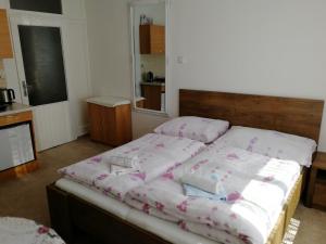 a room with a bed with four pillows on it at Apartment Mora in Mariánské Lázně