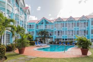 a resort with a swimming pool and palm trees at Bay Gardens Marina Haven in Gros Islet