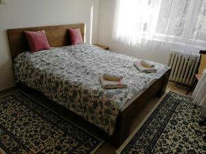 a bedroom with a bed with two pillows on it at Apartment Mora in Mariánské Lázně