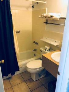 a bathroom with a toilet and a sink and a shower at North Wind Motel in North Wildwood