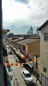 a city street with cars parked in a parking lot at Hospedaje Centro in Huancayo