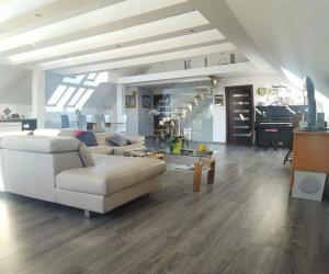 a living room with a white couch and a table at Apartamenty Holiday Slaw jacuzzi bilard,zakaz imprez in Ustarbowo