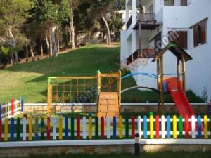 a colorful fence with a playground in front of a house at Bella Vista in Cabo Negro
