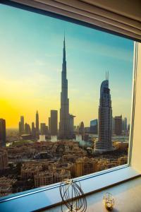 a window with a view of a city and mountains at Boutique Living - Burj Views Downtown Dubai in Dubai