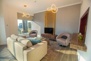 a living room filled with furniture and a couch at Boutique Living - Burj Views Downtown Dubai in Dubai