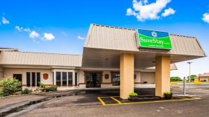 a supermarket with a sign on the front of it at SureStay Hotel by Best Western Higginsville in Higginsville