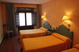 Cama o camas de una habitación en Hotel Fray Tomás