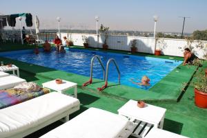 a swimming pool with people playing in the water at St.Joseph Hotel in Luxor