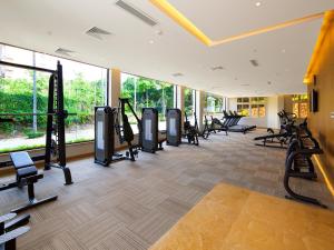 a gym with rows of treadmills and ellipticals at Xiamen C&D Hotel-Free Welcome Snacks-Oasis Garden in Xiamen