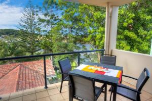 a table and chairs on a balcony with a view at oceanview 6 with rooftop terrace & spa in Nambucca Heads