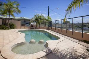 a small swimming pool in the middle of a building at oceanview 6 with rooftop terrace & spa in Nambucca Heads