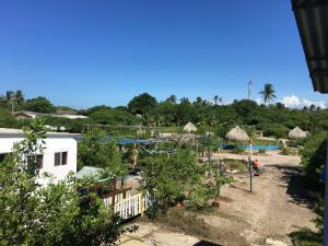 Blick auf einen Garten mit Bäumen und Pool in der Unterkunft Galerazambahostal in Galerazamba