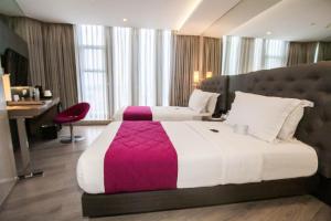 A bed or beds in a room at Hotel XYZ