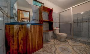 a bathroom with a wooden sink and a toilet at Mar Inn Costa Rica in Monteverde Costa Rica